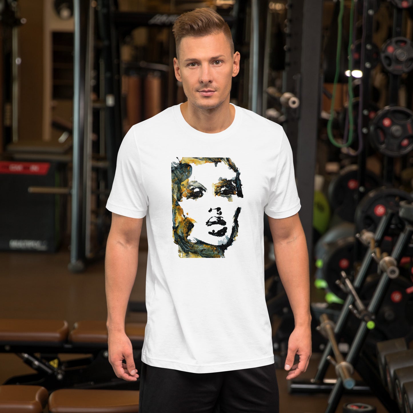 Man wearing a white t-shirt with a bold abstract face in gold and black – artwork by Ilaria Berenice.