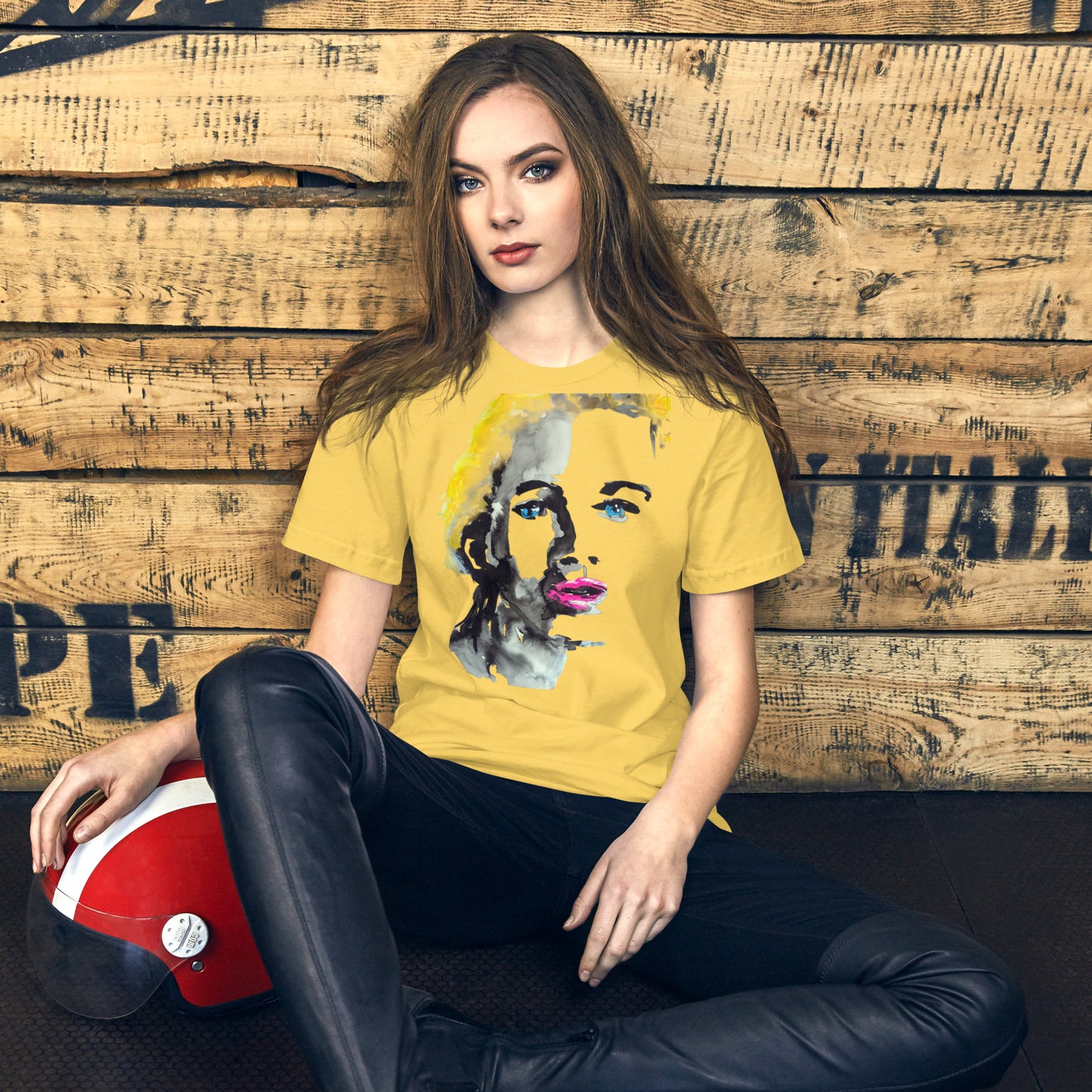 Woman wearing a t-shirt with a vivid yellow and pink abstract face – radiant expression – by Ilaria Berenice.