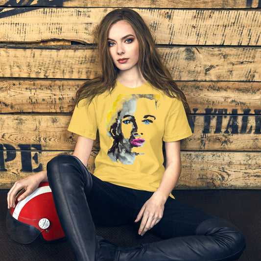 Woman wearing a t-shirt with a vivid yellow and pink abstract face – radiant expression – by Ilaria Berenice.